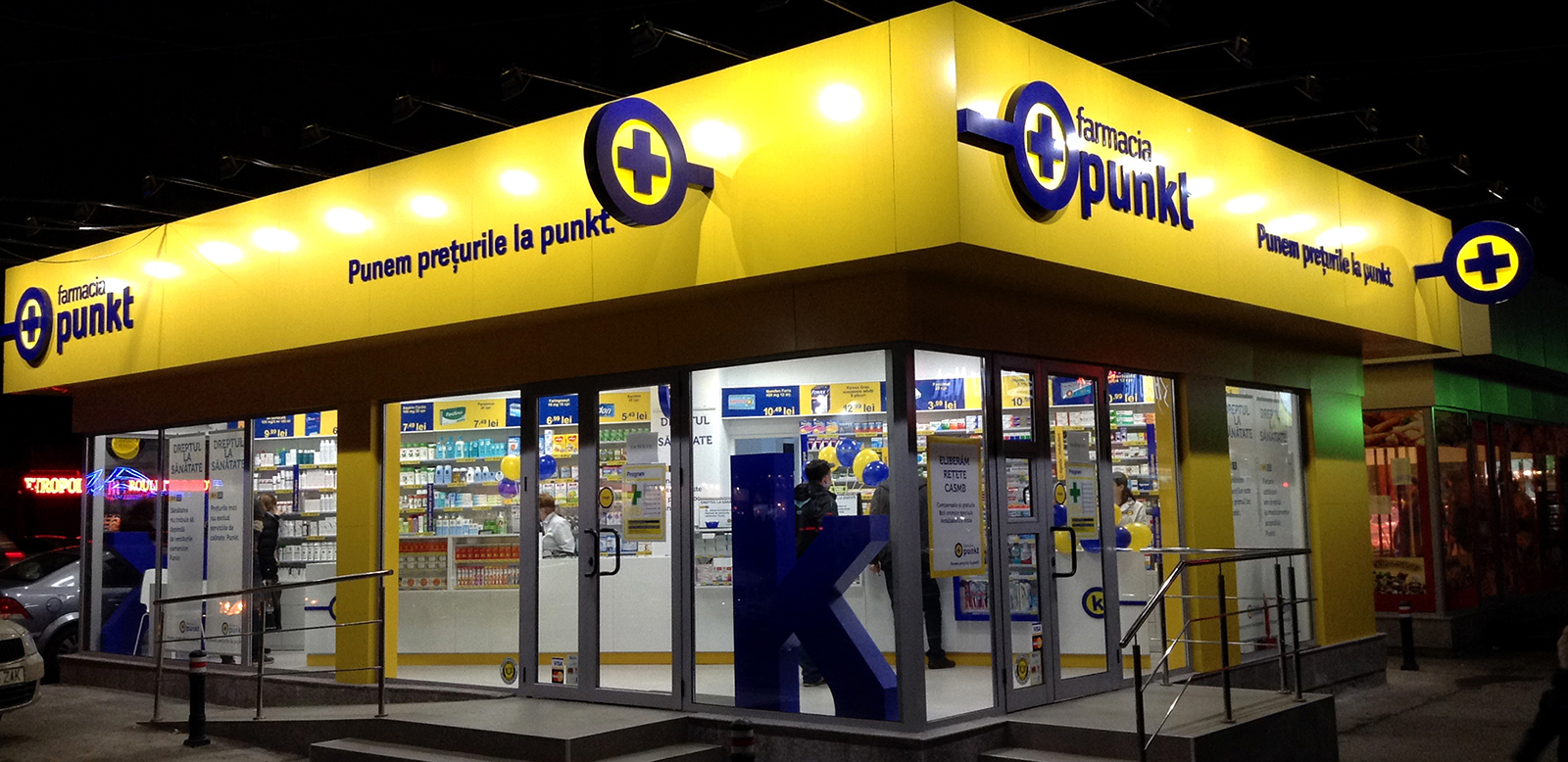 Punckt Pharmacy facade at night-time