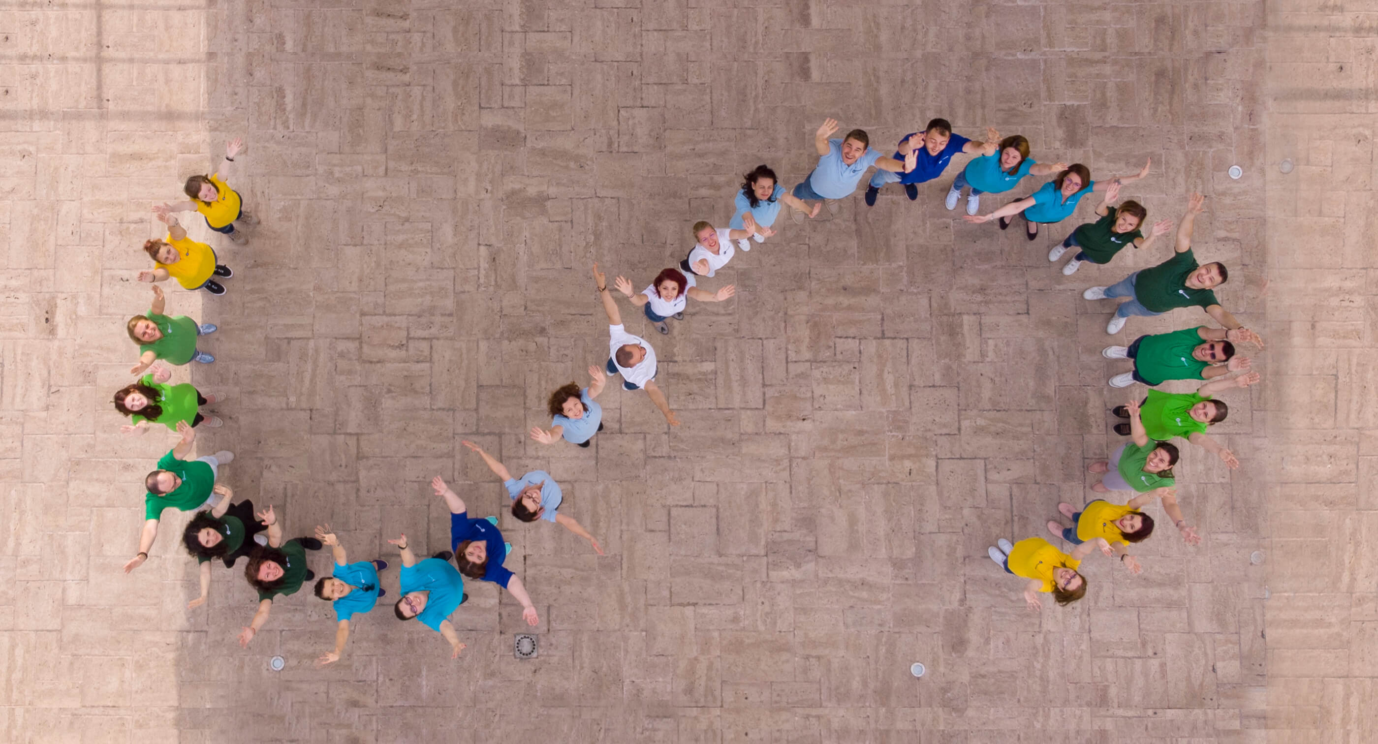 SmartBill team arranged in an S shape and dressed in the brand
